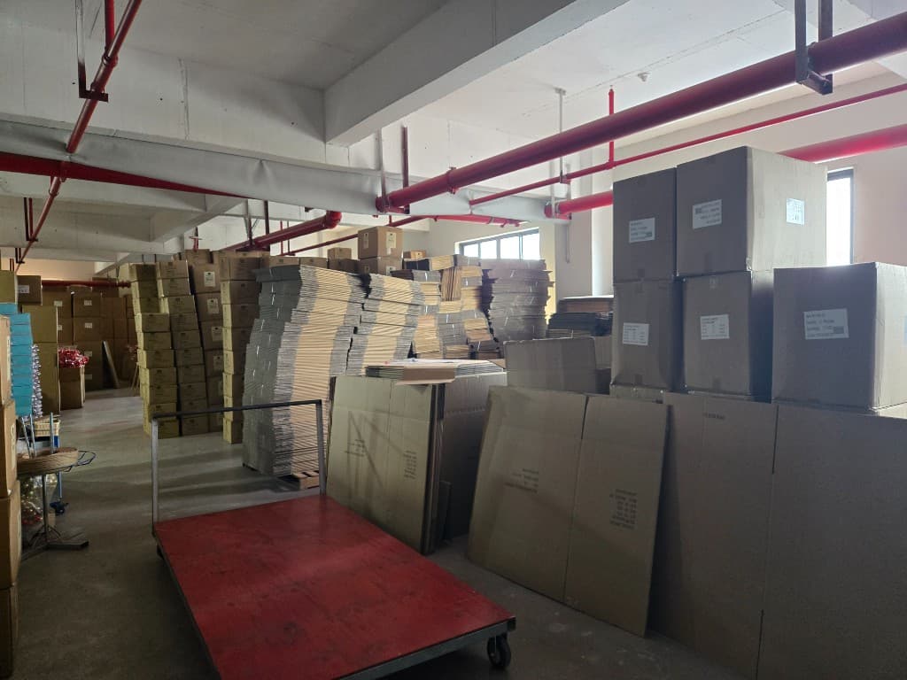 Christmas wreath factory warehouse with export cartons, packaging materials, and bulk staging for wholesale orders