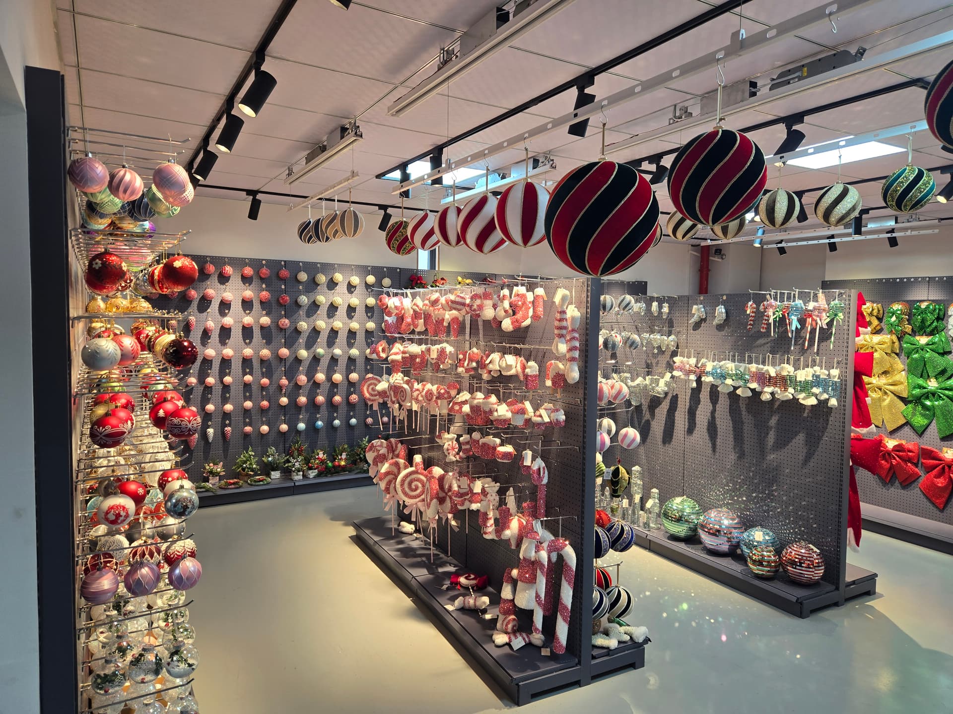 Organized Christmas ornament showroom floor with bulk production display racks