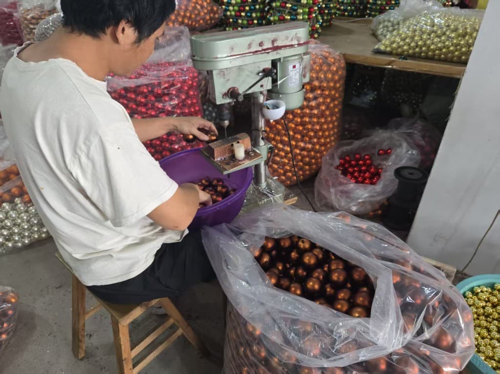 Christmas ornament cap fitting and bulk bronze bauble production with high-volume bagged inventory in the workshop
